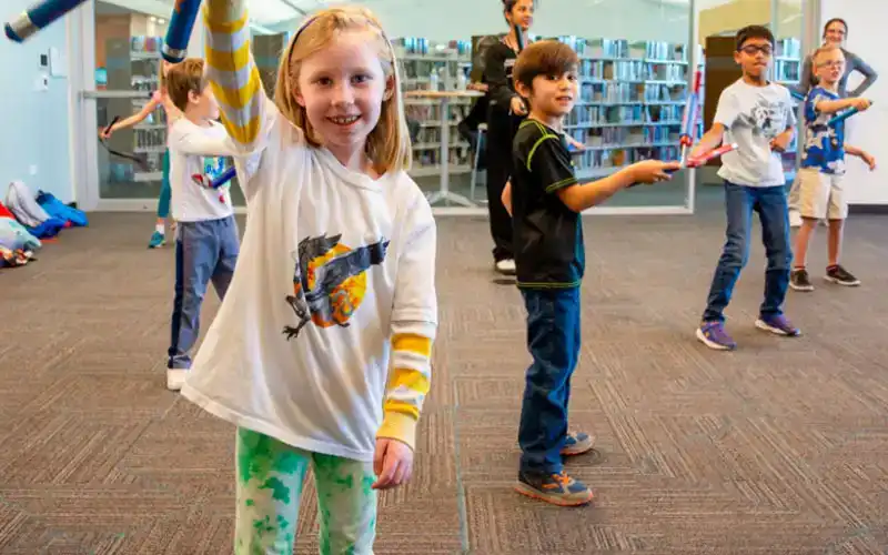 Children and adults participating in activities in a bright community space